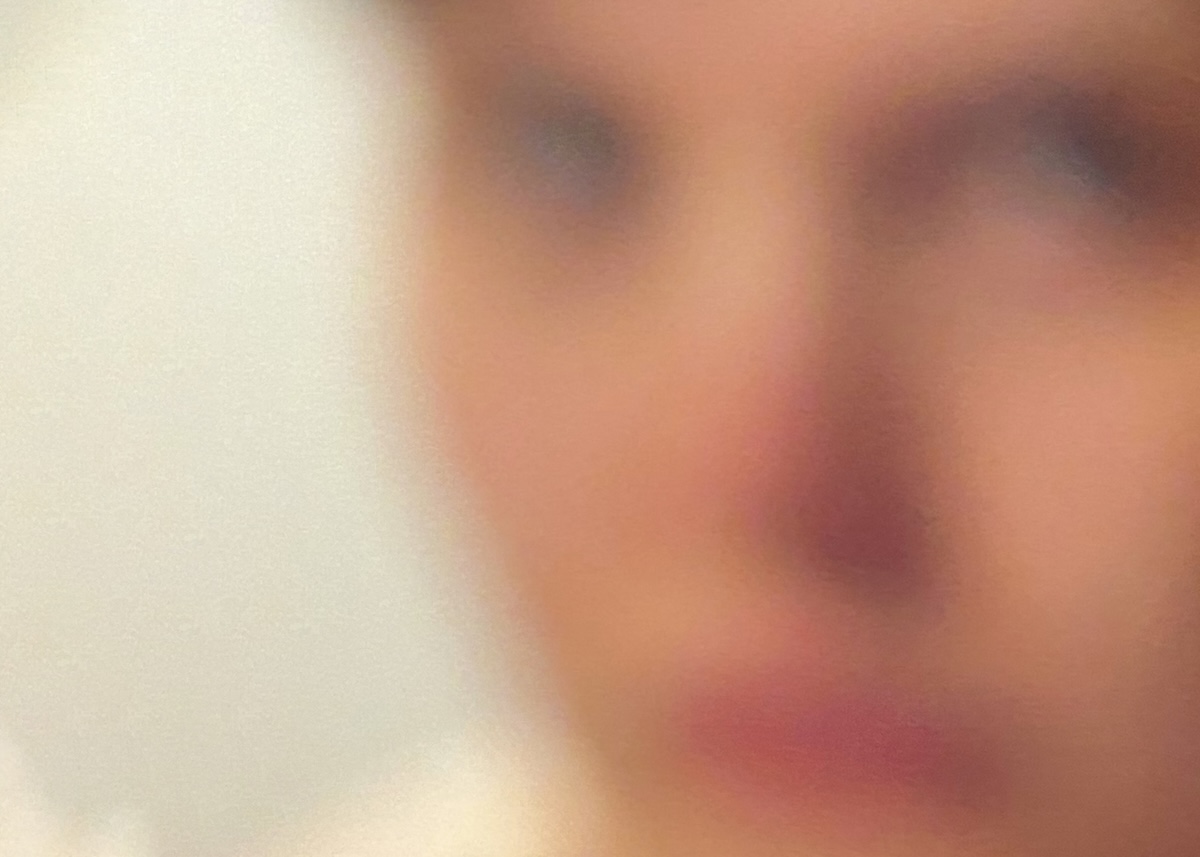 A blurry closeup of a person.